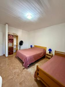 a bedroom with two beds in a room at Departamentos MR in Villa Elisa