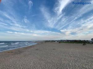 a beach with a blue sky and the ocean at The Melrose in Ocean Grove
