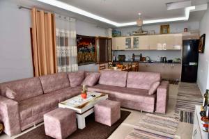 a living room with a couch and a table at Villa Romario in Berat