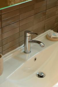 a bathroom sink with a chrome faucet on it at Modern house! in Iráklia +9 photos