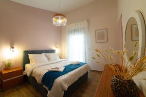 a bedroom with a bed with two towels on it at Modern house! in Iráklia