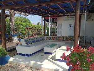 a bench sitting under a pavilion with a playground at Cabanas Recreaciones in Coveñas