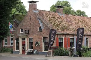 ein Backsteingebäude mit Schildern davor in der Unterkunft De Jagersloft in Wedde