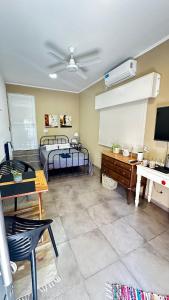 a living room with two beds and a tv at Casa AMBAR in Concordia