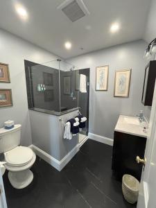 a bathroom with a toilet and a shower and a sink at Saltair Inn Waterfront B&B in Bar Harbor +71 photos