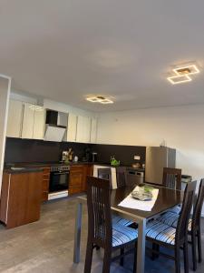 a kitchen with a table and chairs in a room at Adiferienwohnung1 in Gerolstein