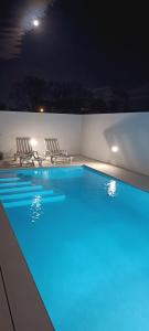 a swimming pool at night with blue lights at Brava in Vila Franca do Campo