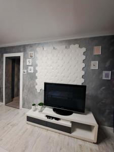 a living room with a flat screen tv on a wall at JULIA Apartament- Oświęcim in Oświęcim