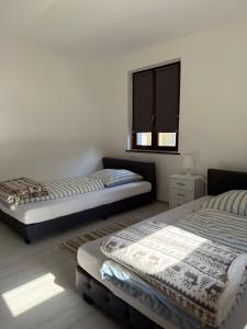 a bedroom with two beds and a window at Adiferienwohnung1 in Gerolstein