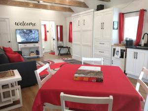 a living room with a table with a red table cloth at Garden Guest Cottage in Harrisonburg