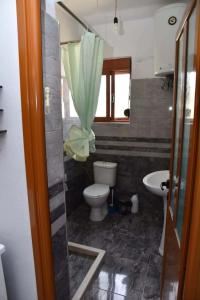 a bathroom with a toilet and a sink at Villa Romario in Berat +28 photos