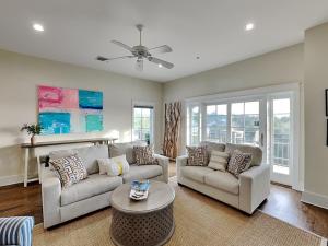 a living room with two couches and a table at Eastern Lake Village #E - Just 4 Fun in Seagrove Beach