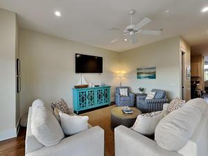 a living room with two white couches and a flat screen tv at Eastern Lake Village #E - Just 4 Fun in Seagrove Beach