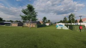 a yard with two tents on the grass at Minicamping Ons Weitje in Koudekerke