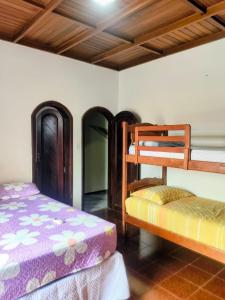a bedroom with two bunk beds in a room at Casa com Piscina Grande em Salinas in Salinópolis +26 photos