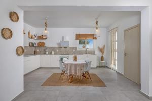 a kitchen with a table and chairs in a room at Villa Pastida - Boutique Luxury Villa on Rhodes with Private Pool in Pastida
