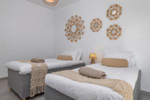 a room with two beds with blankets and mirrors on the wall at Villa Pastida - Boutique Luxury Villa on Rhodes with Private Pool in Pastida +56 photos