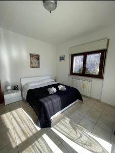 a bedroom with a bed with two stuffed animals on it at Il Giardino di Luna in Poggio Nativo