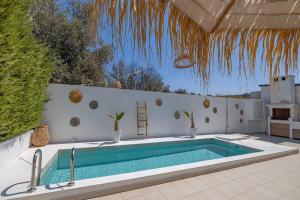 a swimming pool in the middle of a patio at Villa Pastida - Boutique Luxury Villa on Rhodes with Private Pool in Pastida