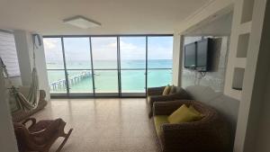 a living room with a view of the ocean at Beachfront apartment in Salinas Malecom in Salinas