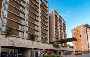 two tall buildings on a street in a city at Apartment in Torre Empiria in Torreón
