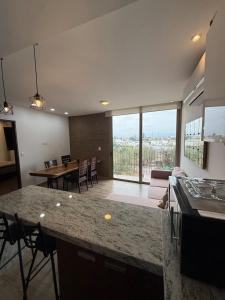 a kitchen and living room with a view of the city at Apartment in Torre Empiria in Torreón