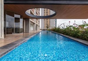 a swimming pool in the middle of a building at Apartment in Torre Empiria in Torreón