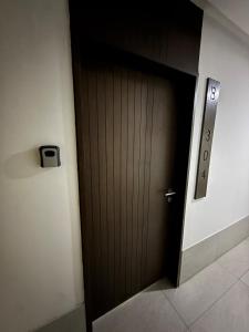 a dark wooden door in a hallway at Apartment in Torre Empiria in Torreón +8 photos