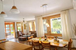 a dining room and living room with a table and chairs at Къща за гости Бели Вит in Ribarica