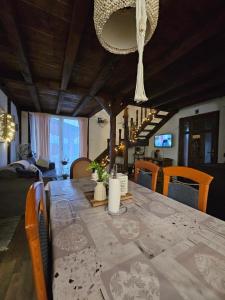 a dining room with a long table and chairs at Imanje Pelko in Zlatar Bistrica