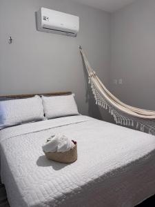 a bedroom with a bed with a basket on it at Casa Solmar Guriú in Guriú