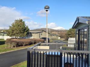a porch with a fence and a street light at Glasyln 37 in Porthmadog