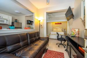 a living room with a couch and a bed at The Allenhurst in Ocean Grove