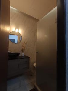 a bathroom with a sink and a mirror at Monoambiente Dos Lunas in Resistencia +4 photos
