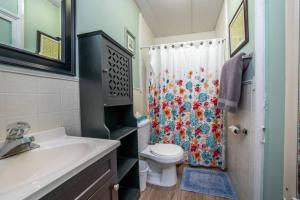 a bathroom with a toilet and a shower curtain at The Allenhurst in Ocean Grove +14 photos