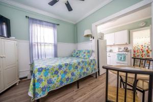 a small bedroom with a bed and a kitchen at The Allenhurst in Ocean Grove