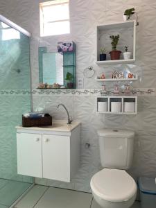 a white bathroom with a toilet and a shower at Casa Solmar Guriú in Guriú +43 photos