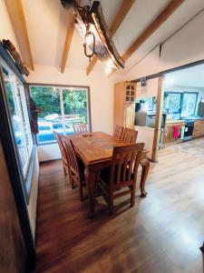 a dining room with a wooden table and chairs at Refugio PARQUE NACIONAL ALERCE ANDINO in Puerto Montt