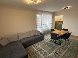 a living room with a couch and a table at Martin's Apartment in Bansko