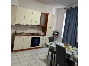 a kitchen and dining room with a table and a table and chairs at Fiore Apartments in Fiorenzuola dʼArda