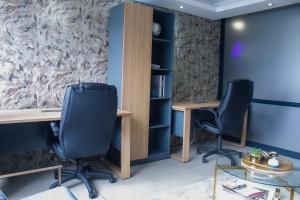 an office with two desks and two chairs at The Millennial, Secure parking, 3 mins to Gateway in Durban +6 photos