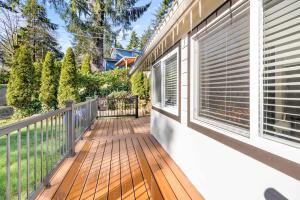 a balcony of a house with a window at Bright Beach Town Bungalow in Gleneden Beach