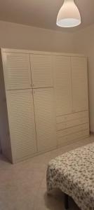 a bedroom with white closets and a bed in it at Colonne Blu in Ginosa Marina