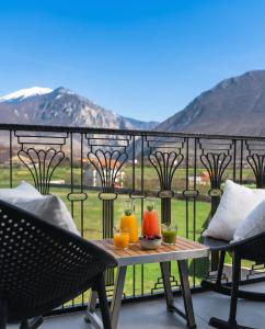 a table with drinks on top of a balcony at Leo Hotel in Kukës