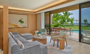 a living room with couches and tables and a pool at The St. Regis Cap Cana Resort in Punta Cana