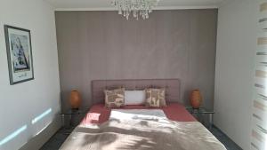 a bedroom with a bed and a chandelier at Erdgeschosswohnung in Künzelsau