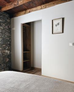 a bedroom with a door leading to a closet at La Casina de Isoba in Isoba