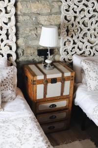 a table with a lamp on it next to two beds at La Casina de Isoba in Isoba