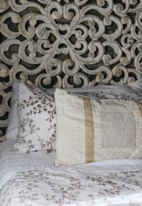 a bed with a headboard with a pillow on it at La Casina de Isoba in Isoba +20 photos