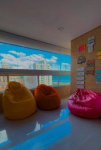 three bean bags sitting on the floor in a room at Ilha Salinas Canto do Forte in Praia Grande